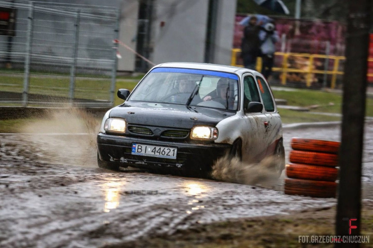 Crew with the rally Micra in the paddock